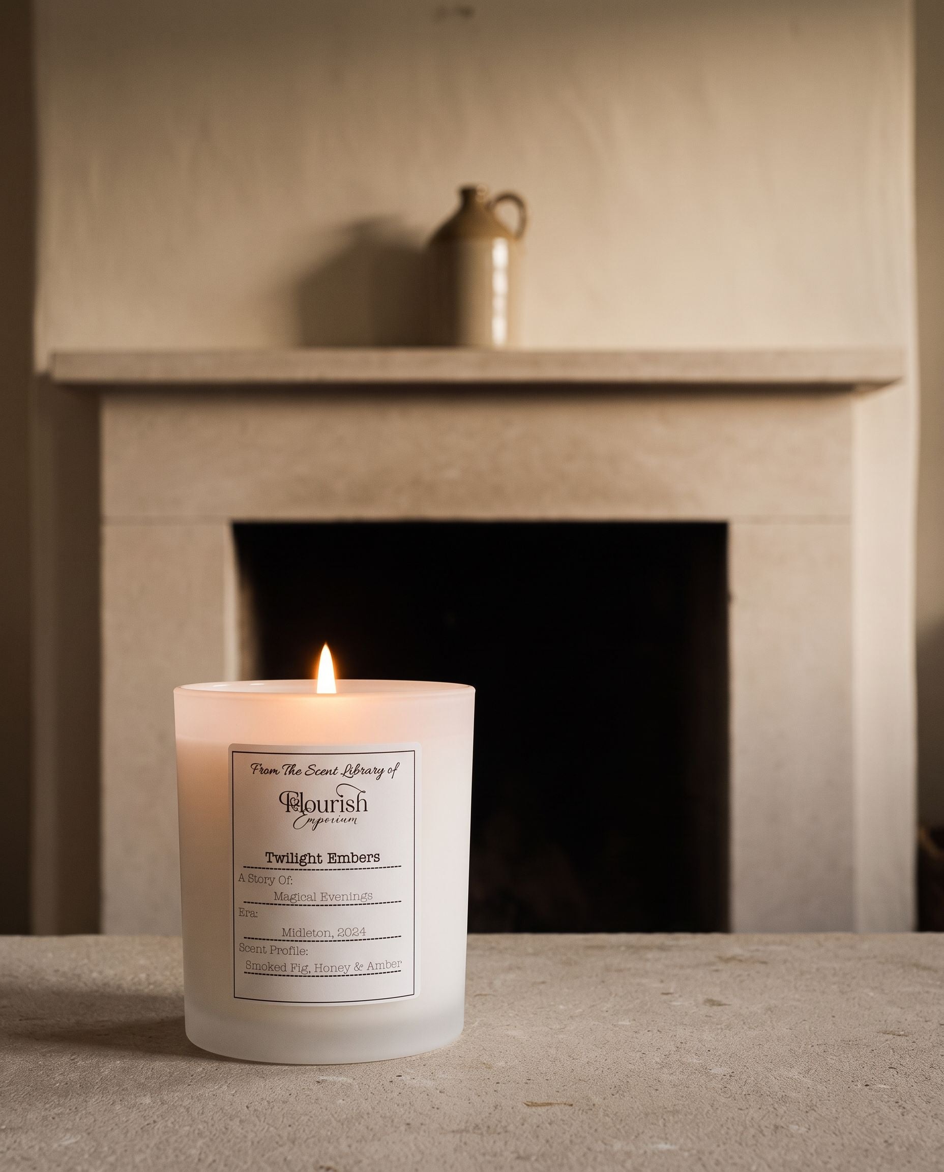 Twilight Embers candle lit on a pale limestone hearth in the evening